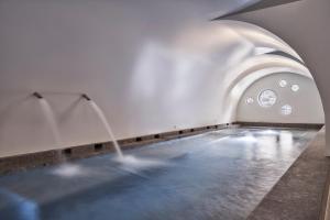 a pool of water in a room with a fountain at Orama Hotel & Spa in Fira