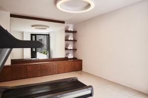 a living room with a fireplace and a mirror at Orama Hotel & Spa in Fira
