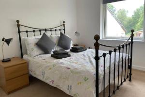 a bedroom with a bed and a window at Woodside retreat holiday home in Aviemore in Aviemore