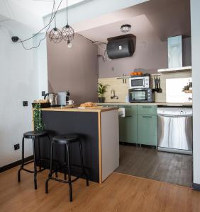 a kitchen with a counter and stools in a room at Alicante Mediterraneo View in Alicante