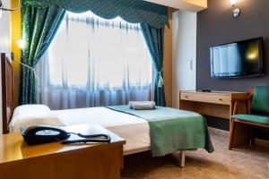 a hotel room with a bed and a television at Hotel Silva in Ferrol