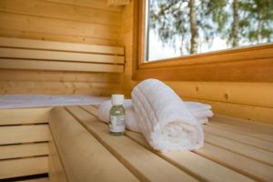 a sauna with a towel and a bottle of medicine at Landhaus Bockelmann, Natur trifft Komfort in Bispingen +57 photos