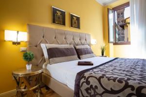 a bedroom with a large bed and a table at Boutique Hotel del Corso in Florence