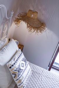 a bedroom with a bed with a pillow and a fan at Althea Apartments 2 in Halki