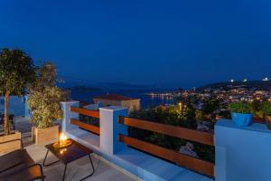 a balcony with a view of the city at night at Althea Apartments 2 in Halki