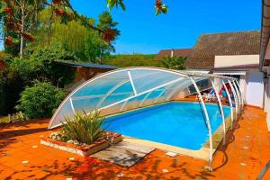 a swimming pool with a glass bridge over it at Villa Lilly 2 piscine et jardin privé 8 chambres in Pierry