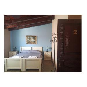 a bedroom with a bed and two night stands at L' Antica Trebbia - Rooms in Caltanissetta
