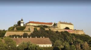 a house on top of a hill with houses on it at Cosy Novi Sad loft, self check-in in Petrovaradin