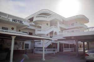 a large white building with balconies and a hotel at Las Palmas Hotel in Corozal