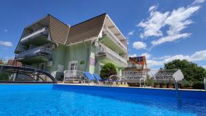 a view of a house with a swimming pool at Green Guesthouse Balatonfüred in Balatonfüred