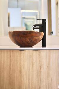a wooden bowl on a counter with a bathroom sink at ESTUDIO PORT EXPERIENCE in Tarragona