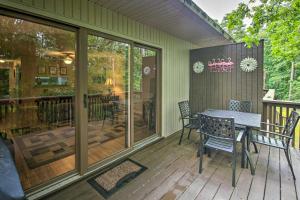 a patio with a table and chairs on a deck at Cozy Retreat with Deck 3 Mi to DeSoto Golf Course! in Hot Springs Village