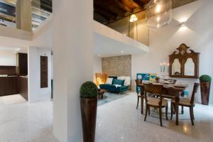 a dining room and living room with a table and chairs at ItaliaHaus - Ca' Olivo loft with canal view in Rialto Venice in Venice