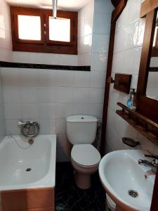 a bathroom with a toilet and a sink at Las Rocas de Brez in Brez