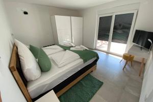 a bedroom with a bed and a desk and a television at Villa Lighthouse mit Pool und Jacuzzi in Bašanija +26 photos