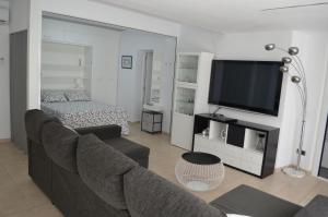a living room with a couch and a flat screen tv at Estrena loft en el mejor sitio de Tarragona in Tarragona