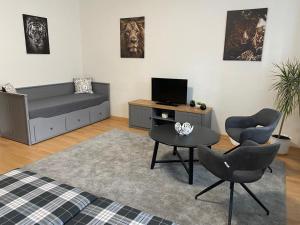 a living room with a couch and a table and chairs at Apartmány Černý Tulipán 1 in Plzeň