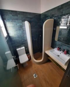 a bathroom with a sink and a shower and a mirror at Nerajoula House in Parga +35 photos