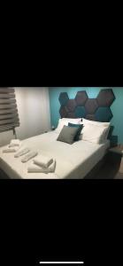 a bedroom with a large bed with white sheets and pillows at STREET 90 LuX APARTS in Keramotí