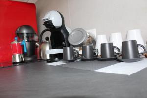 a counter with cups and other items on it at SunnyCornerinRHome in Rome