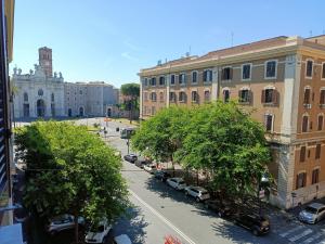 a city street with cars parked in front of buildings at SunnyCornerinRHome in Rome