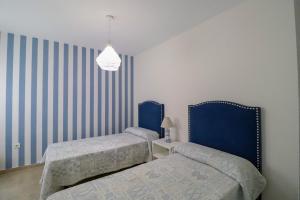 Posteľ alebo postele v izbe v ubytovaní Ohana Beachfront