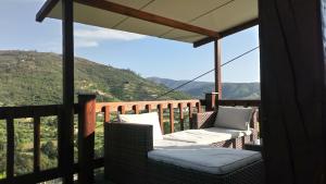 a balcony with two chairs and a view of a mountain at Rustialva-8Adultos-4crianças in Avô