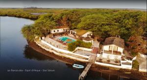 an aerial view of a house in the middle of a river at Les Barracudas in Sokone