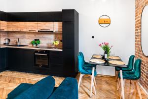 a kitchen and dining room with a table and chairs at Heart of the Old WROCLOVE in Wrocław