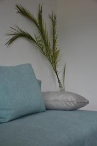 a pillow sitting on top of a bed with a plant at Bache Apartments in Ohrid