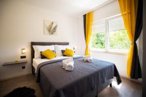 a bedroom with a bed with two towels on it at Villa Nila Zadar in Zadar +35 photos