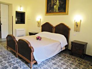 a bedroom with a large bed with flowers on it at B&B Dei Bottai in Gallipoli