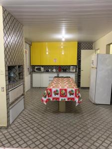 a kitchen with a table and a refrigerator at Hostel da Paz in Maceió +14 photos