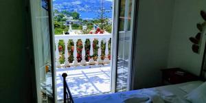 a room with a window with a view of a balcony at Angelika in Alinda +70 photos