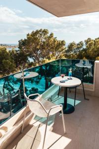 a patio with a table and chairs on a balcony at City Beach Makarska in Makarska