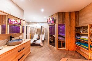 a bathroom with wooden walls and a sink and a mirror at Murtal Suiten in Zeltweg +22 photos