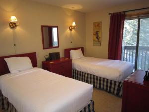 a hotel room with two beds and a window at Vail Racquet Club Mountain Resort in Vail