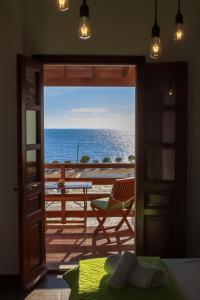 a room with a view of the ocean through a door at Mistral-Patmos in Patmos
