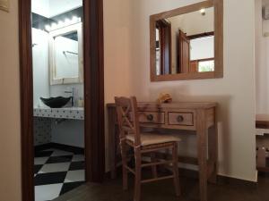 a bathroom with a wooden desk and a mirror at Mistral-Patmos in Patmos