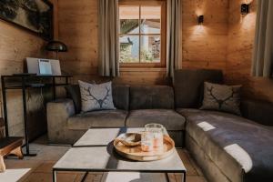 a living room with a couch and a table at Chalet Watzmann in Schönau am Königssee