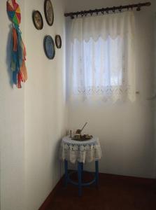 a small table in a room with a window at Violet Bedroom and Apartment in Spata