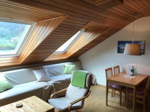 a living room with a couch and a table at FeWo Gipfelglück in Willingen