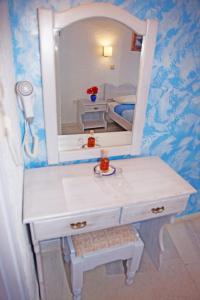 a bathroom with a white sink and a mirror at St.George Valsamitis in Katapola