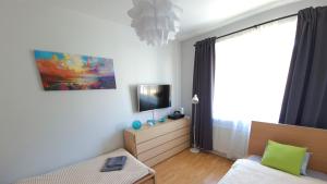 a living room with a couch and a tv at Apartament Miarki 3 in Świnoujście +27 photos