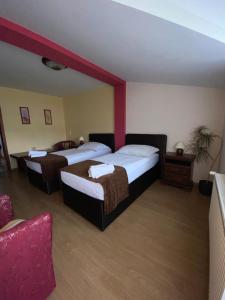A bed or beds in a room at Konsky Dvor