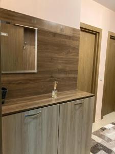 a bathroom with a wooden counter with a mirror at Mirabell Apartment Bansko - Mountain View & Fireplace in Bansko +43 photos