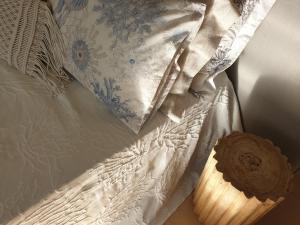 a white comforter and a pillow on a bed at Aretousa Deluxe Downtown Apartment in Skala