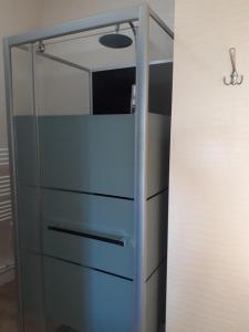 a glass cabinet with drawers in a room at Au coeur des remparts, residence du château* in Gravelines