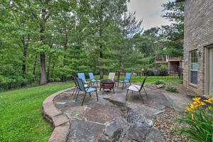 a patio with chairs and a table and a fire pit at Bentonville Home with Pool Table, 2 Mi to Downtown! in Bentonville