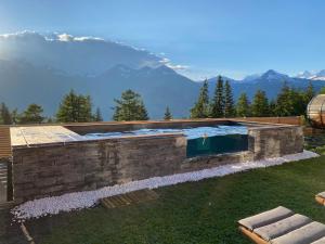 a swimming pool with a mountain in the background at Chalet Béla Vya in Arc 1600